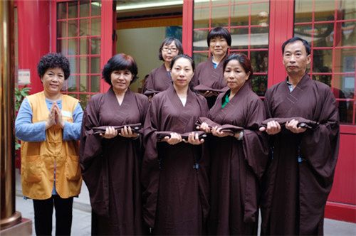 准备求受五戒的六位居士手托幔衣